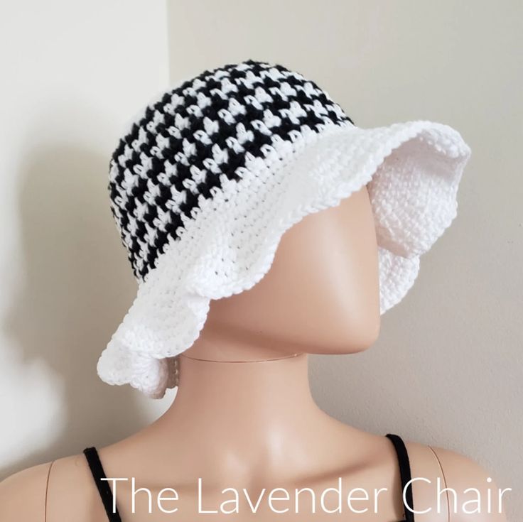 a mannequin head wearing a black and white crochet hat with the words the lavender chair on it