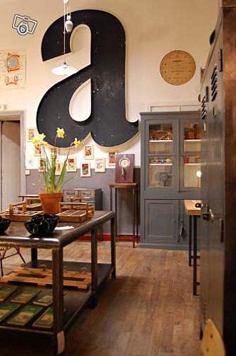 the inside of a restaurant with wooden floors and large letters hanging from the wall above it