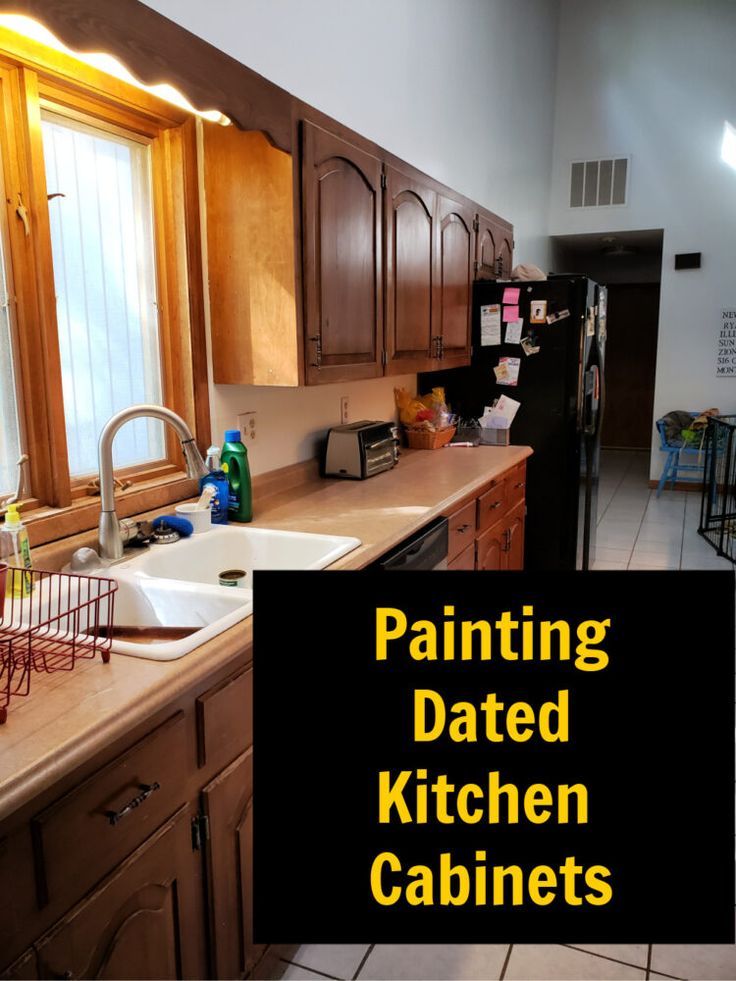 a kitchen with wooden cabinets and white tile flooring that says painting dated kitchen cabinets