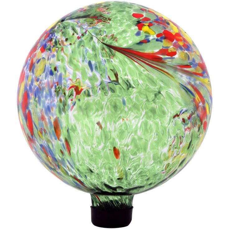 a colorful glass ball sitting on top of a black stand