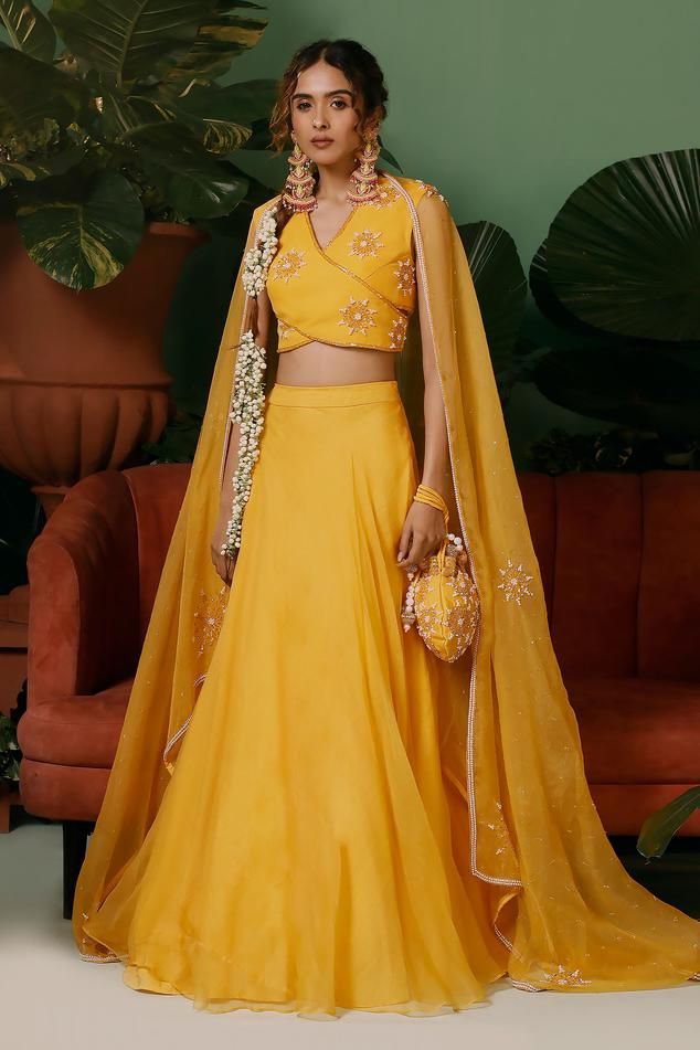 Bright yellow padded blouse with sequin, pearl, cutdana, stone embroidery in star pattern. Paired with attached cancan lehenga and kiran border embroidered dupatta.
Components: 3
Pattern: Embroidery
Type Of Work: Sequin, pearl, cutdana, stone
Neckline: V neck
Sleeve Type: Sleeveless
Fabric: Lehenga: Organza, Blouse and Dupatta: Georgette
Color: Yellow
Other Details: 
Length:
Lehenga: 42 inches
Blouse: 15 inches
Approx. product weight: 2-3kg
Note:
Potli shown in the image is not for sale 
Kindly Yellow Organza Lehenga, Lehenga Black, Sequin Lehenga, Cancan Lehenga, Stone Embroidery, Crop Top Lehenga, Organza Embroidery, Organza Lehenga, Yellow Lehenga