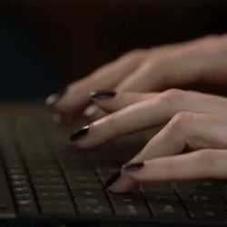 two hands typing on a laptop keyboard