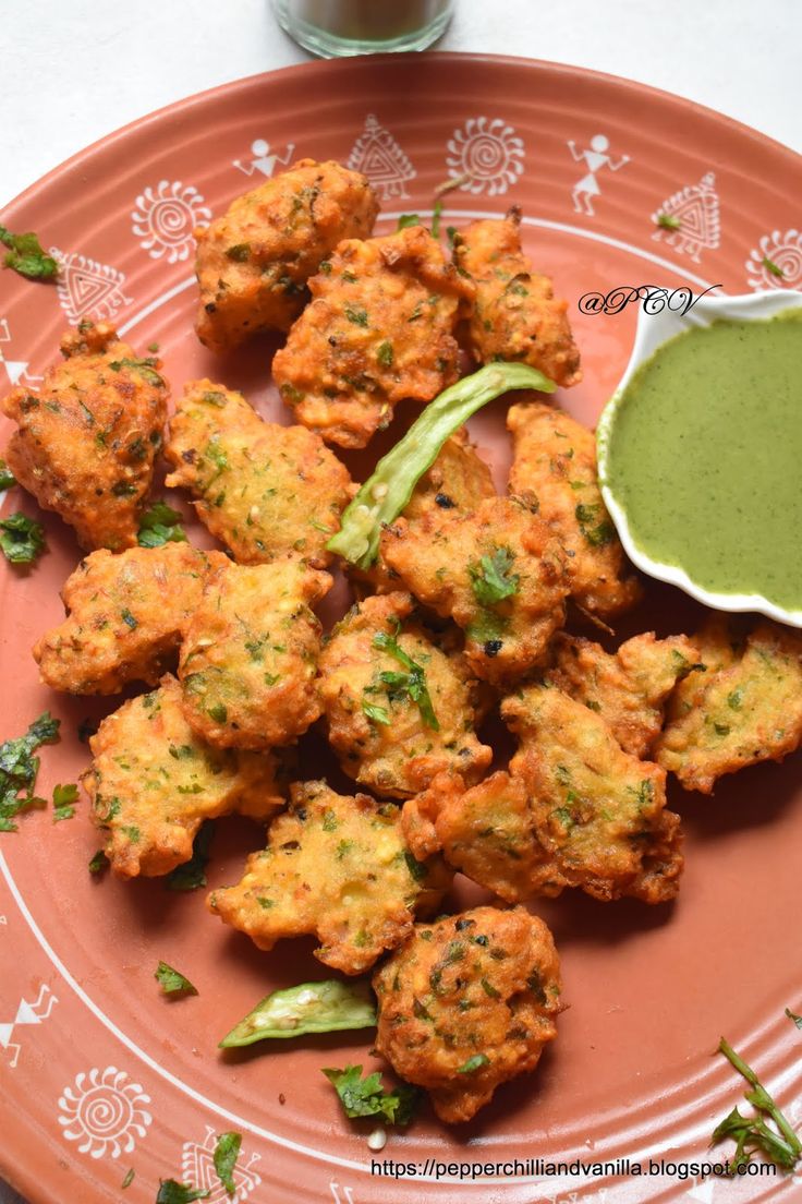 some fried food on a white plate with dipping sauce