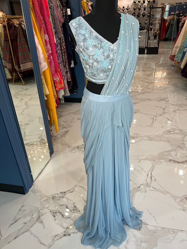 Powder Blue Ready Saree Fitted Pre-draped Saree With Pearl Embroidery For Evening, Elegant Light Blue Choli For Festive Occasions, Elegant Blue Choli For Evening, Elegant Light Blue Festive Choli, Blue Pre-draped Saree With Mirror Work For Party Wear, Blue Floor-length Party Wear Pre-draped Saree, Blue Bollywood Embellished Pre-draped Saree, Semi-stitched Embellished Blue Saree, Blue Floor-length Pre-draped Saree For Parties