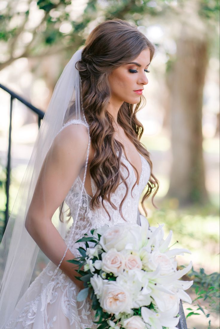 a woman in a wedding dress holding a bouquet