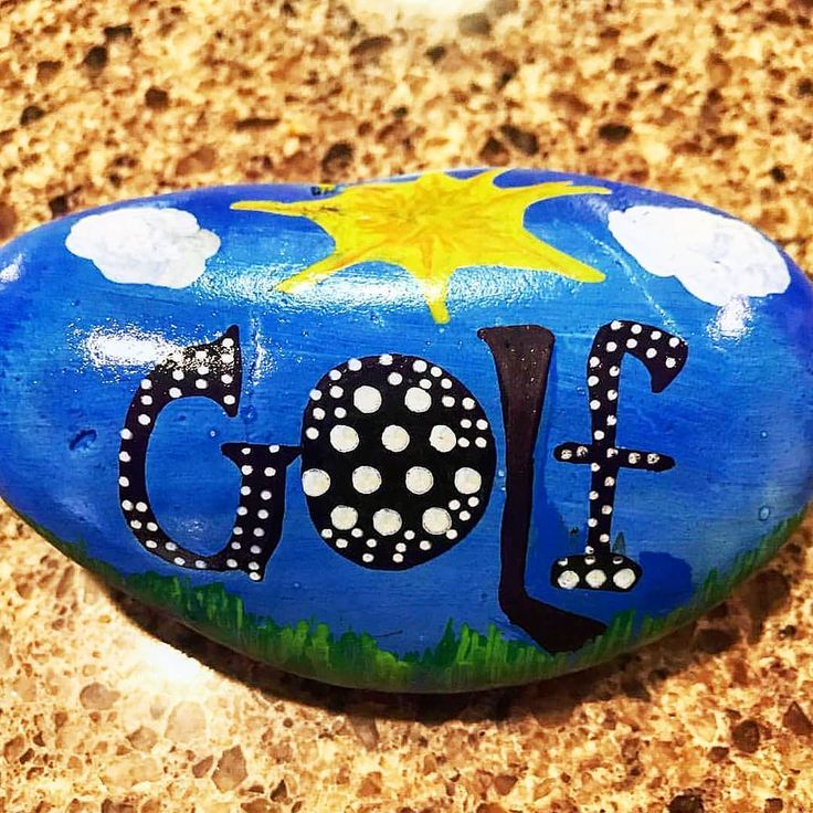 a painted rock with the word golf on it