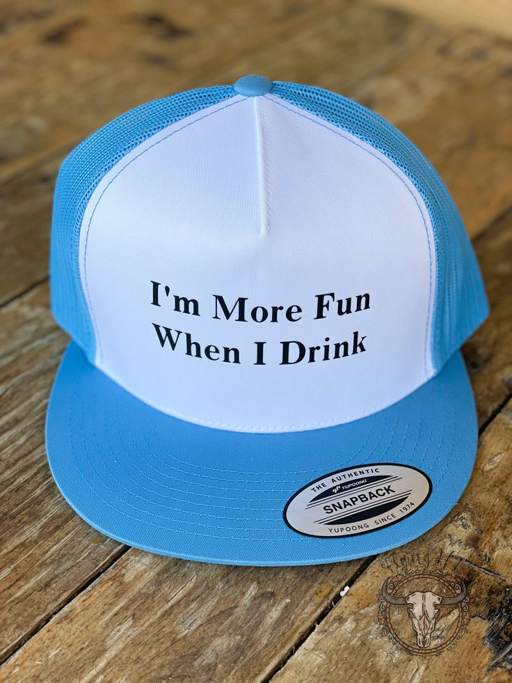 Showcase your fun-loving spirit with this stylish "I'm More Fun When I Drink"Trucker Hat! With its mesh back and adjustable snap-back closure, it's as comfy as it is cool. Let everyone know your mantra in this light blue and white hat. What are you waiting for? Let's have some fun! Drinking Trucker Hats, White Mesh Snapback Hat For Spring, Funny Snapback Trucker Hat, Light Blue Snapback Hat For Summer, Light Blue Snapback Hat, Funny White Adjustable Baseball Cap, Fun Letter Print Baseball Cap With Flat Bill, Fun Flat Bill Baseball Cap With Letter Print, Blue Snapback Hat With Letter Print And Flat Brim