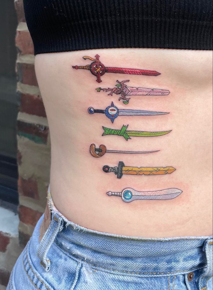 a woman's stomach with many different types of swords on it