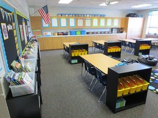 an empty classroom with yellow and black desks