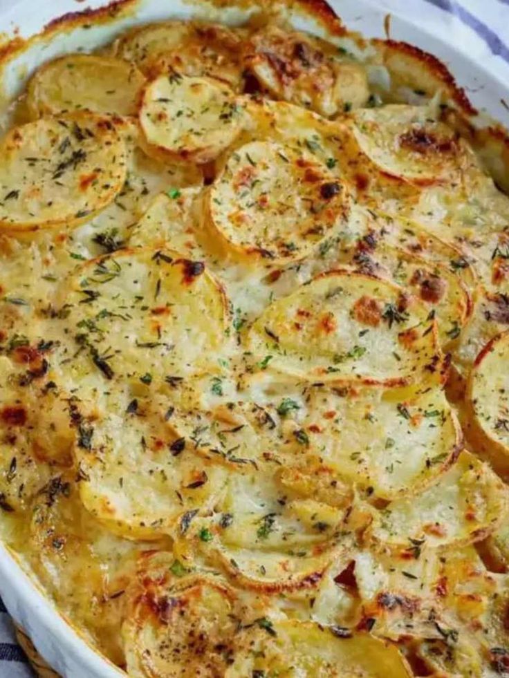 baked potato casserole in a white dish on a blue and white checkered cloth