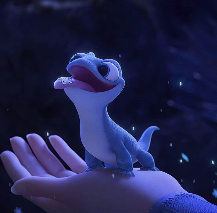 a small toy lizard sitting on top of someone's hand in the animated movie, how to train your dragon