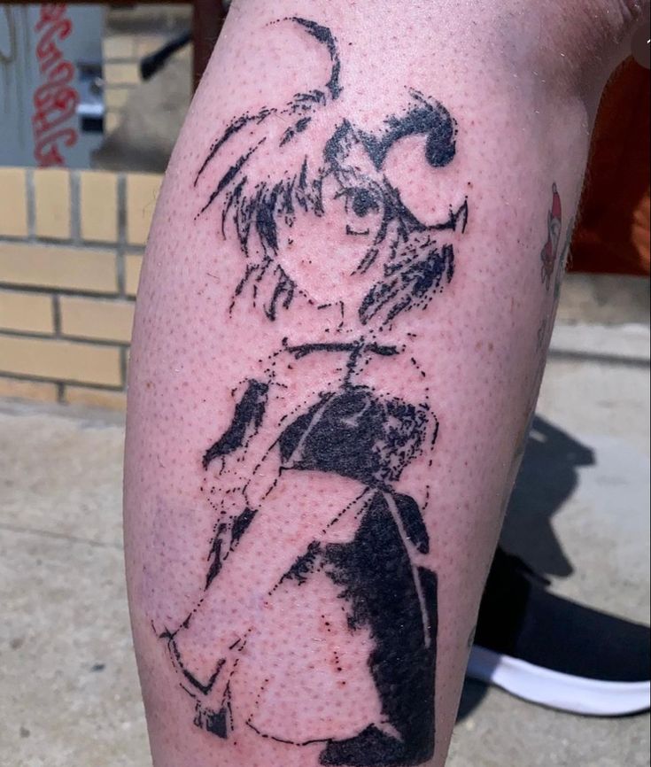 a person with a tattoo on their leg that has an image of a woman and man