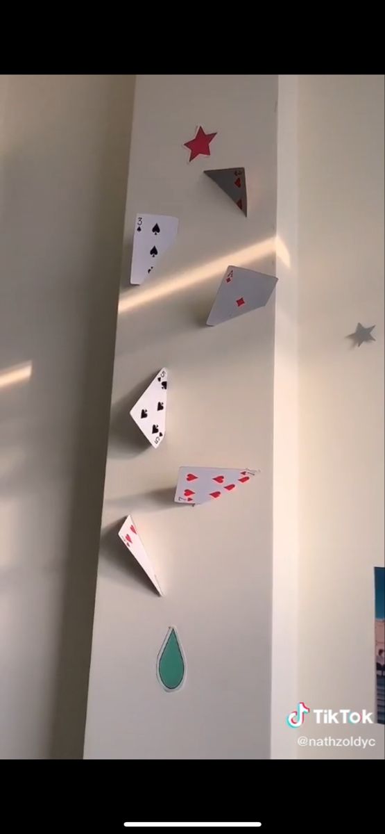 the wall is decorated with playing cards and stars