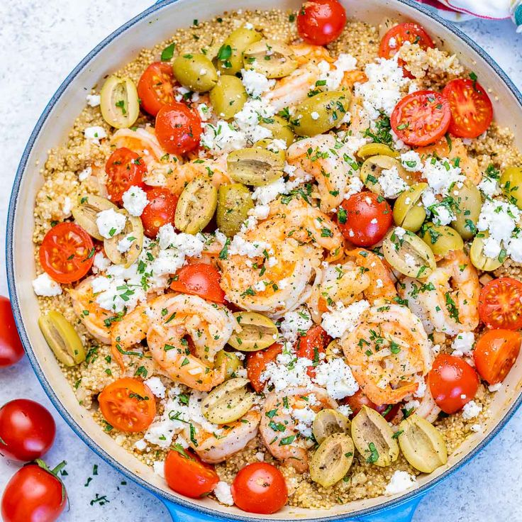 a pan filled with shrimp, tomatoes and feta cheese