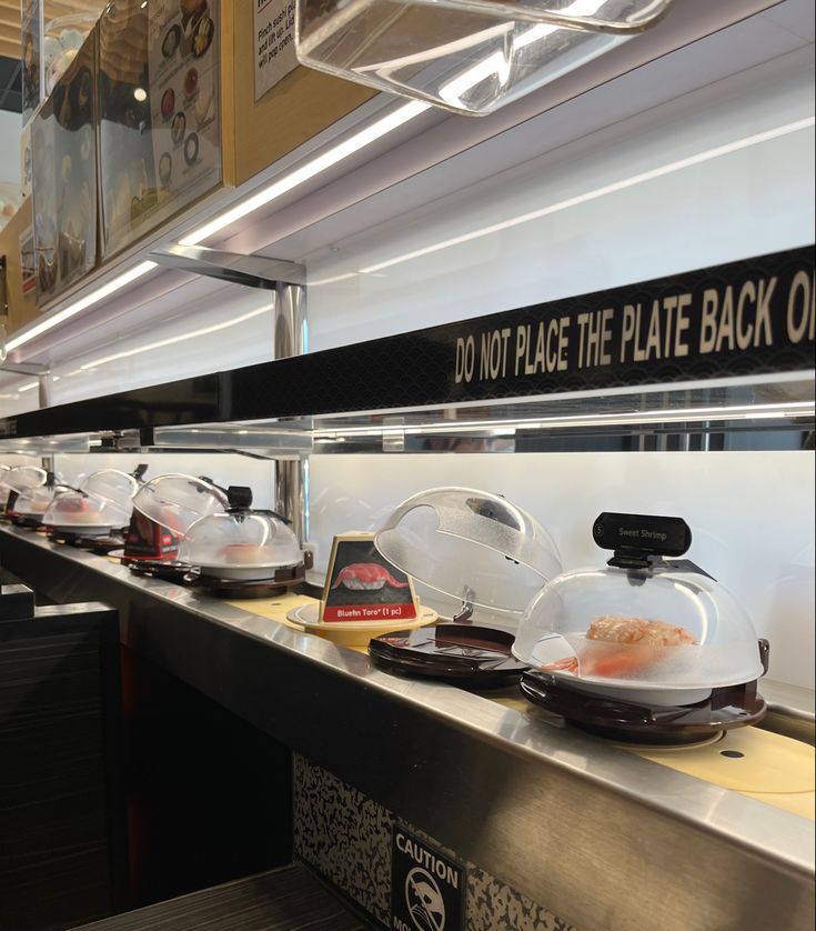 some food is sitting on top of the counter in front of other plates and pans