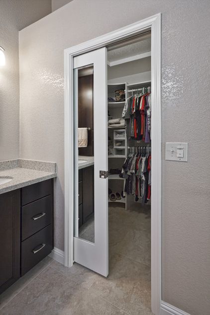 a walk in closet that is next to a sink