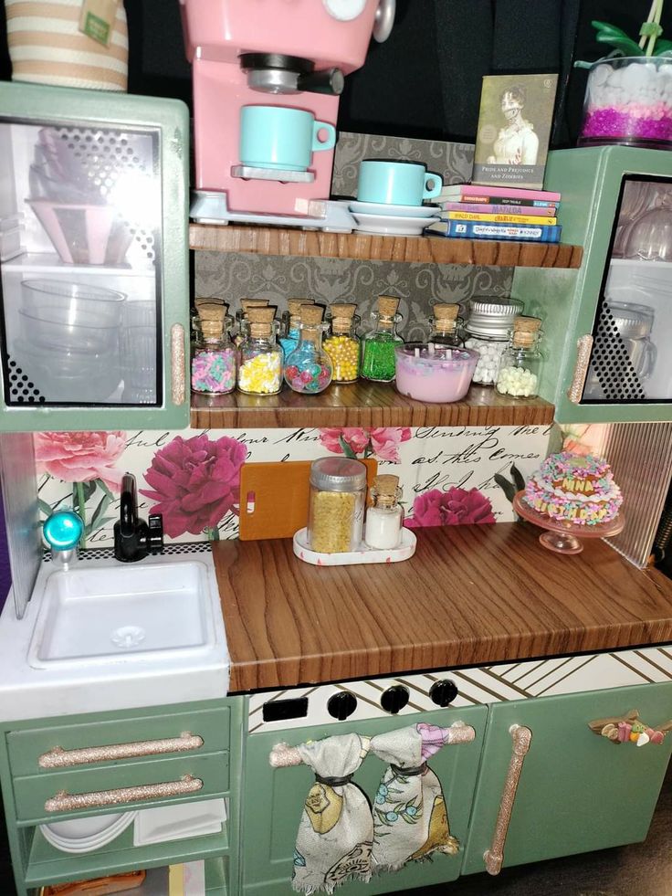 a kitchen with green cabinets and pink appliances