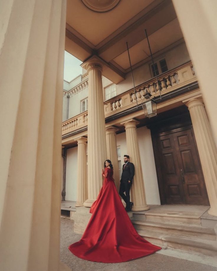 a man and woman standing in front of a building