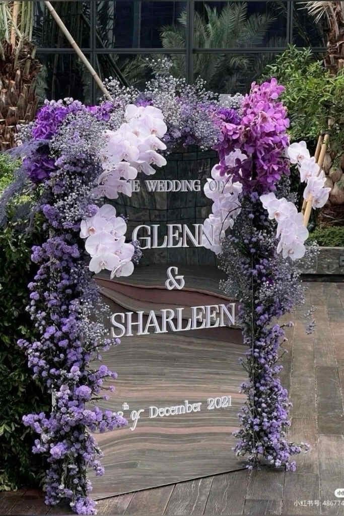 an arch decorated with purple and white flowers