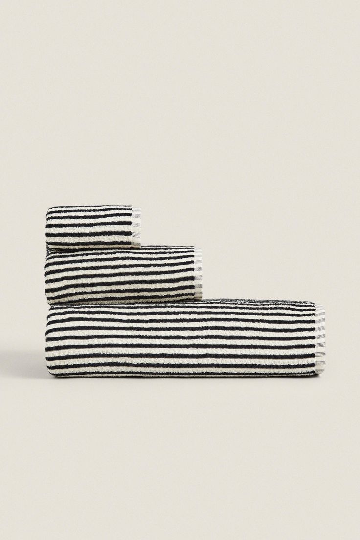 black and white striped towels stacked on top of each other