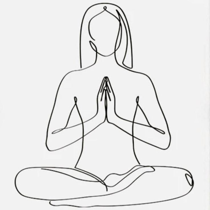 a woman sitting in the lotus position with her hands together