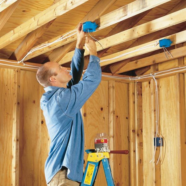 a man is working on the ceiling in his house with tools and equipment around him