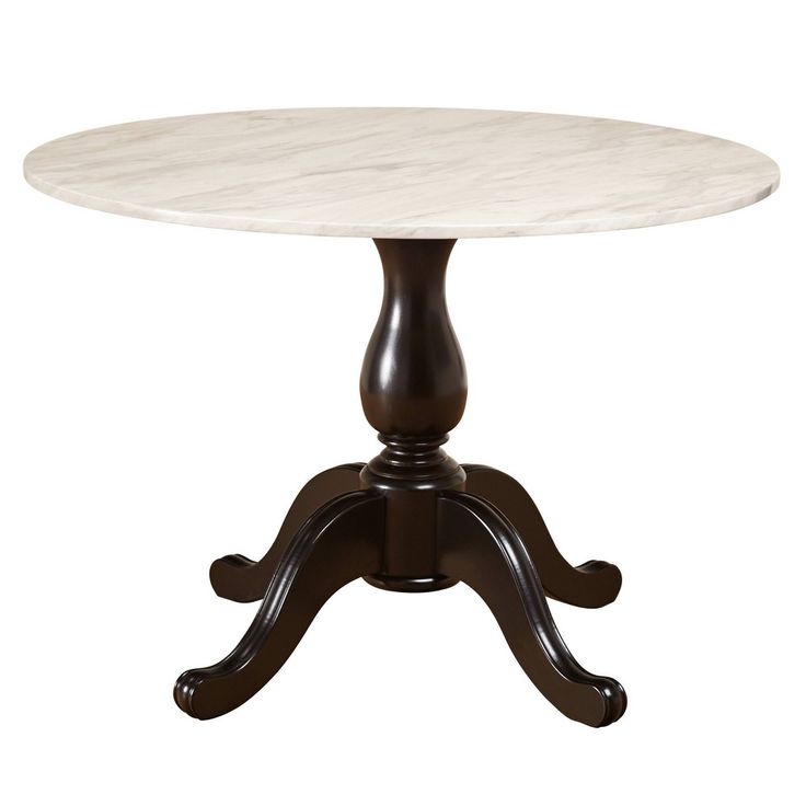 a white marble top dining table with dark wood legs and an ornate base, on a white background