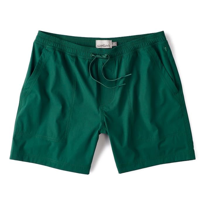 a green shorts with draws on the side and a white tag hanging from the waist