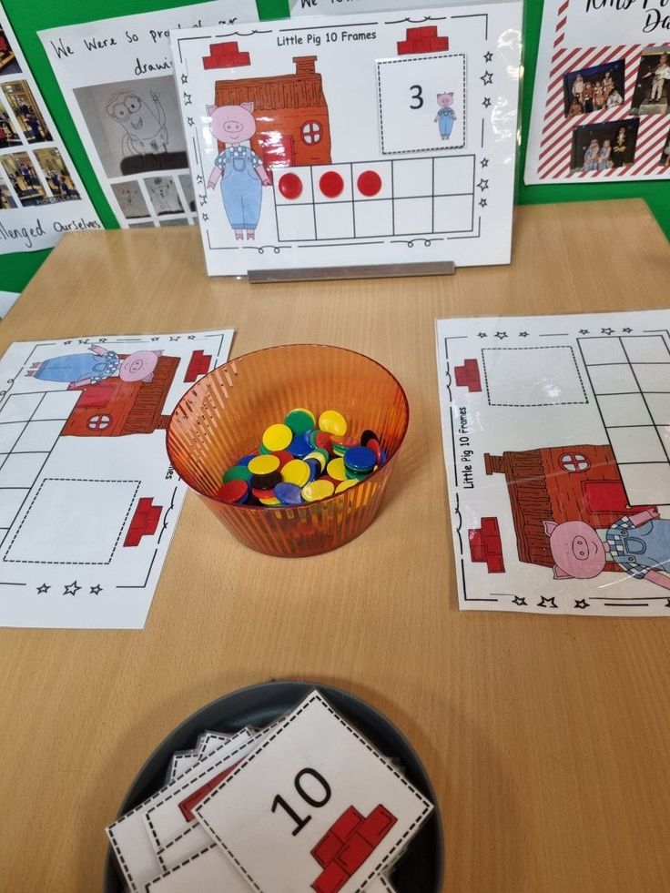 a table topped with lots of cards and bowls filled with different colored candies on top of it