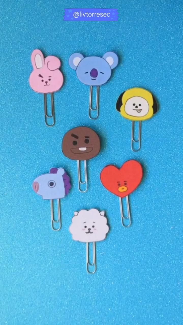 four bear and heart shaped paper clips on a blue background