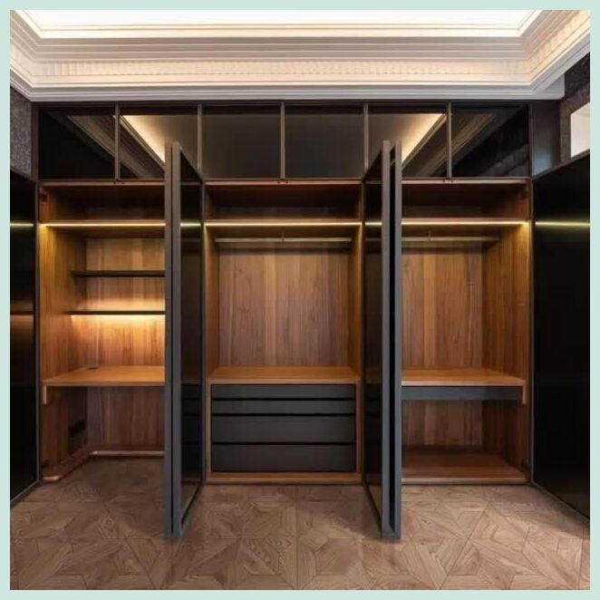 an empty walk in closet with wooden shelves