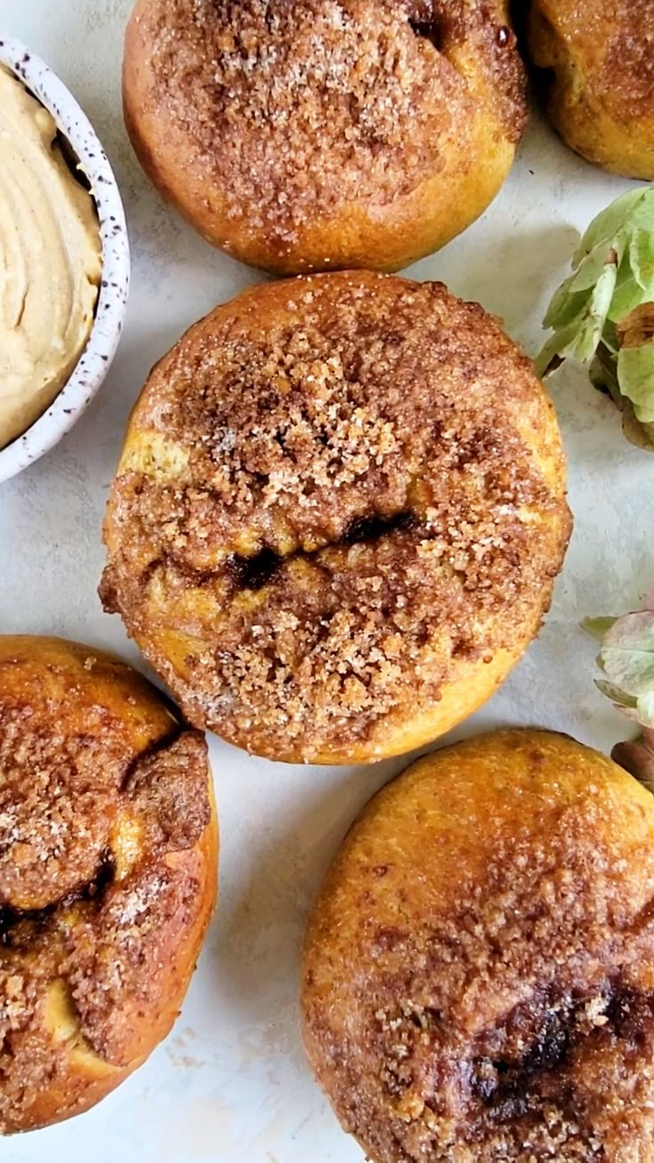 several pastries are sitting on a table next to some dipping sauce and lettuce