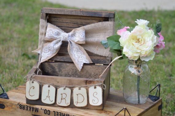 a wooden box with the word dad on it sitting next to a vase filled with flowers