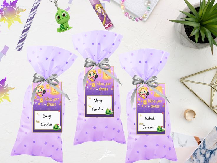 two purple bags with tags on them sitting next to some other items and plants in the background