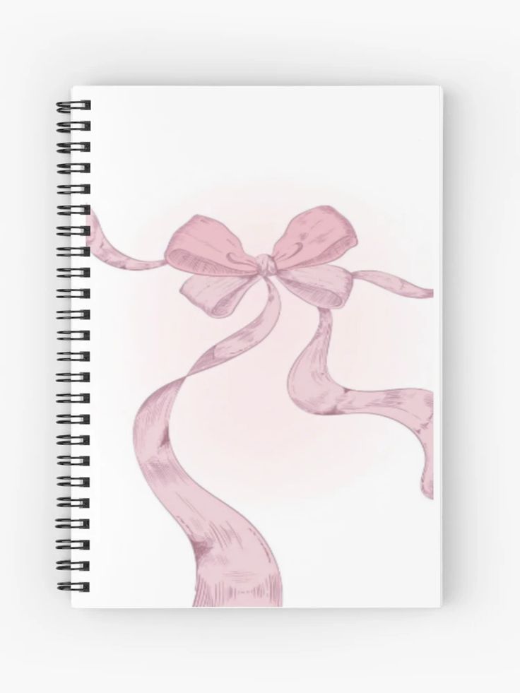 a spiral notebook with a pink ribbon on it