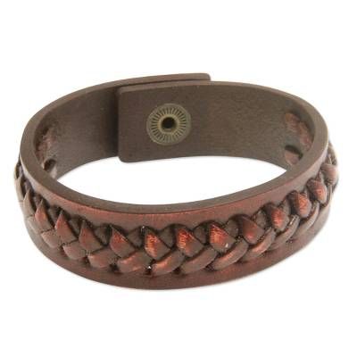 a brown leather bracelet with braiding on it