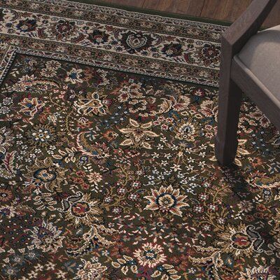 a chair and rug in a room with wooden floors