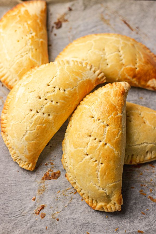 four pastries on a baking sheet ready to be baked