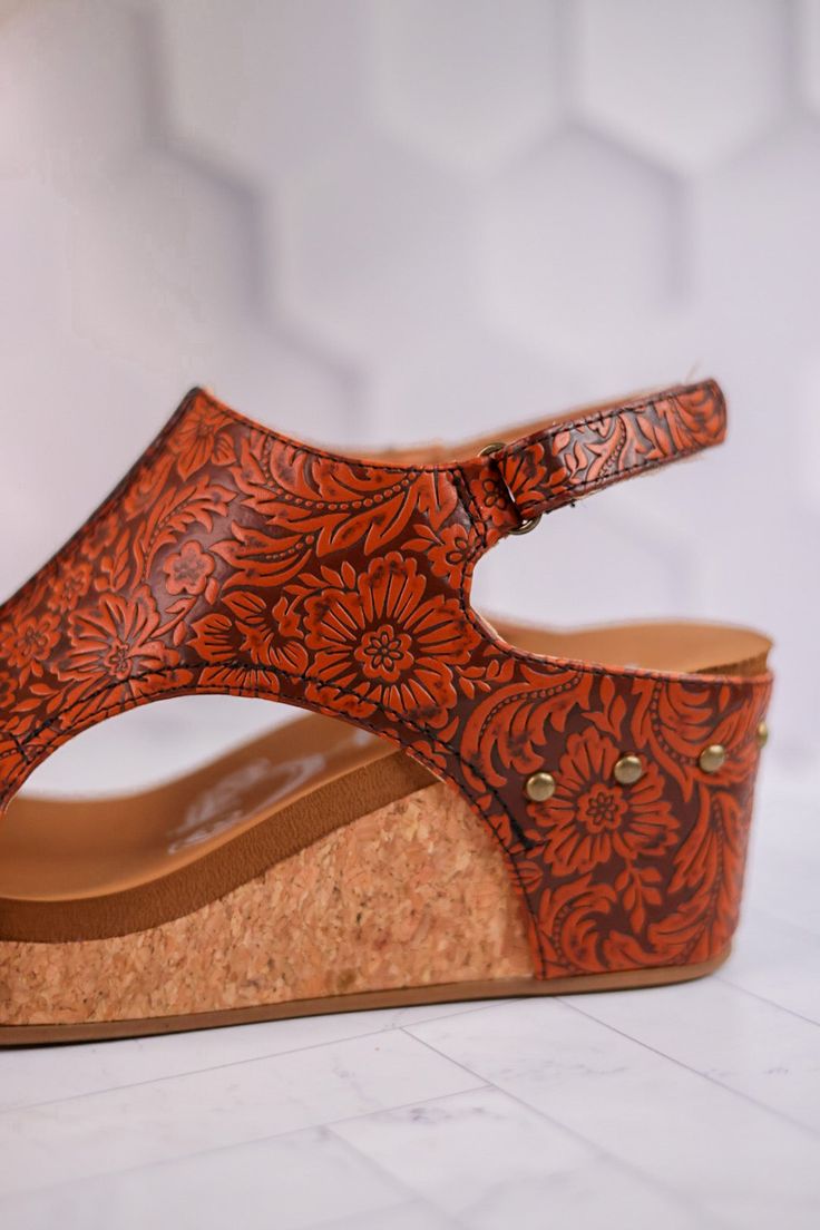 Unleash your potential in the Isabella Tooled Rust Wedge Sandals! With a velcro closure for adjustable support, enjoy all-day comfort and unshakable confidence with every step.Fit: True to Size. If you wear a 1/2 size or have a wide width foot, size up a half size. Heel: 3" Brand: Very G Brown Adjustable Wedge Sandals With Cushioned Footbed, Adjustable Brown Wedge Sandals With Cushioned Footbed, Adjustable Closed Toe Wedge Sandals, Adjustable Wedge Sandals With Arch Support, Comfortable Adjustable Wedge Heel Sandals, Comfortable Adjustable Closed Toe Wedge Sandals, Adjustable Closed Toe Wedge Sandals With Cushioned Footbed, Wedge Sandals With Adjustable Strap And Round Toe, Adjustable Cushioned Closed Toe Wedge Sandals