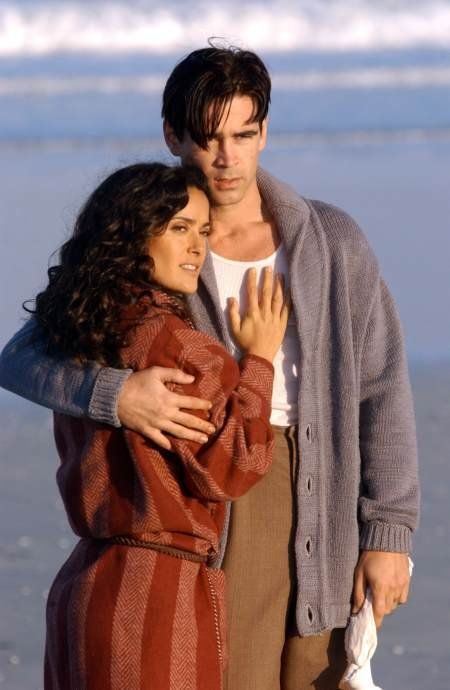 a man and woman hugging on the beach