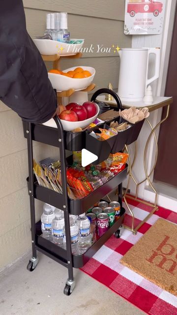 a cart filled with food next to a red and white checkered rug on the floor