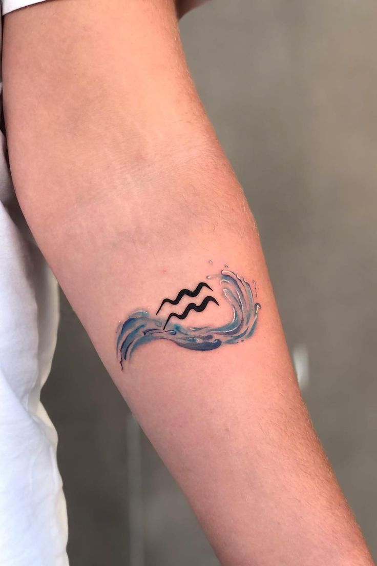 a man's arm with a wave tattoo on it