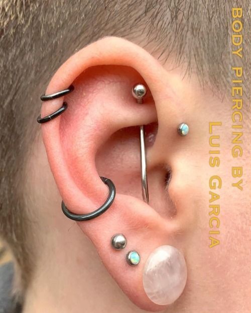 a man with some piercings on his ear