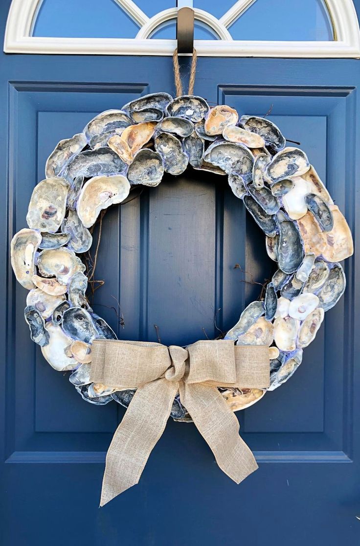 a blue door with a wreath made out of seashells