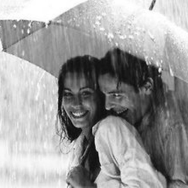 a man and woman under an umbrella in the rain