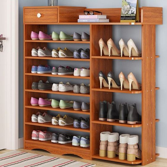 a wooden shoe rack filled with lots of shoes