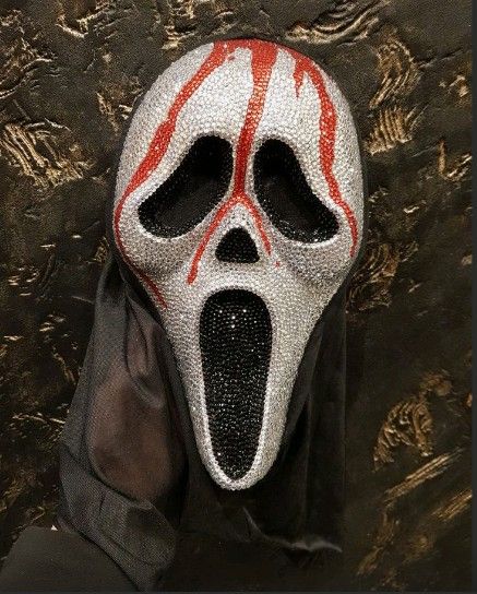 a person wearing a white mask with red lines on it's face and mouth