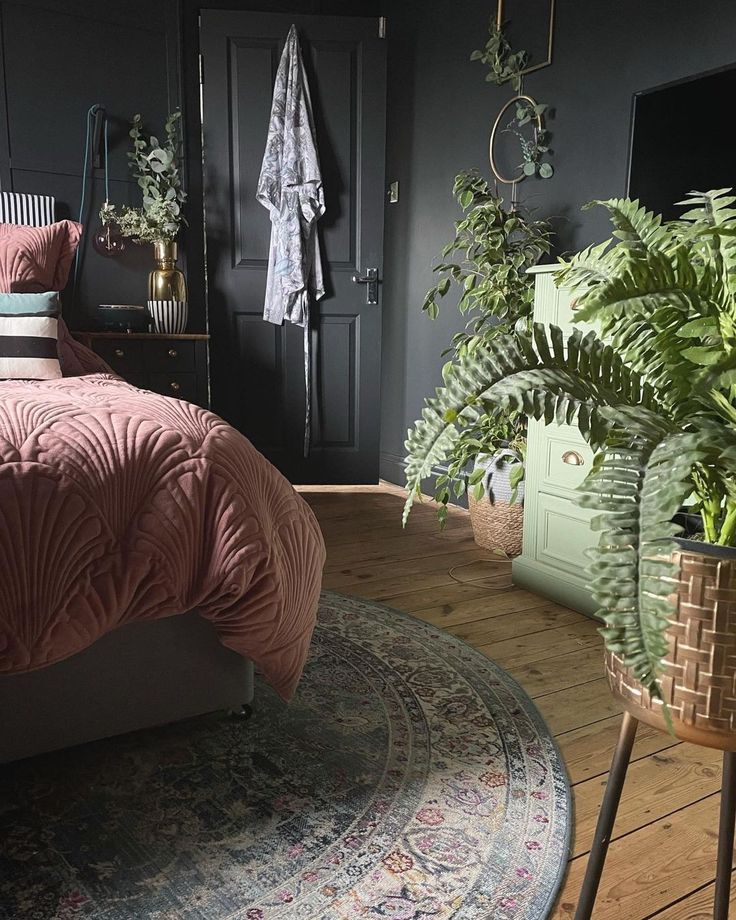 a bedroom with a bed, plant and rug