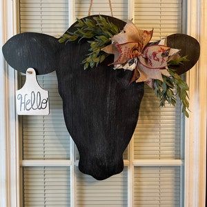 a cow's head is hanging on the front door