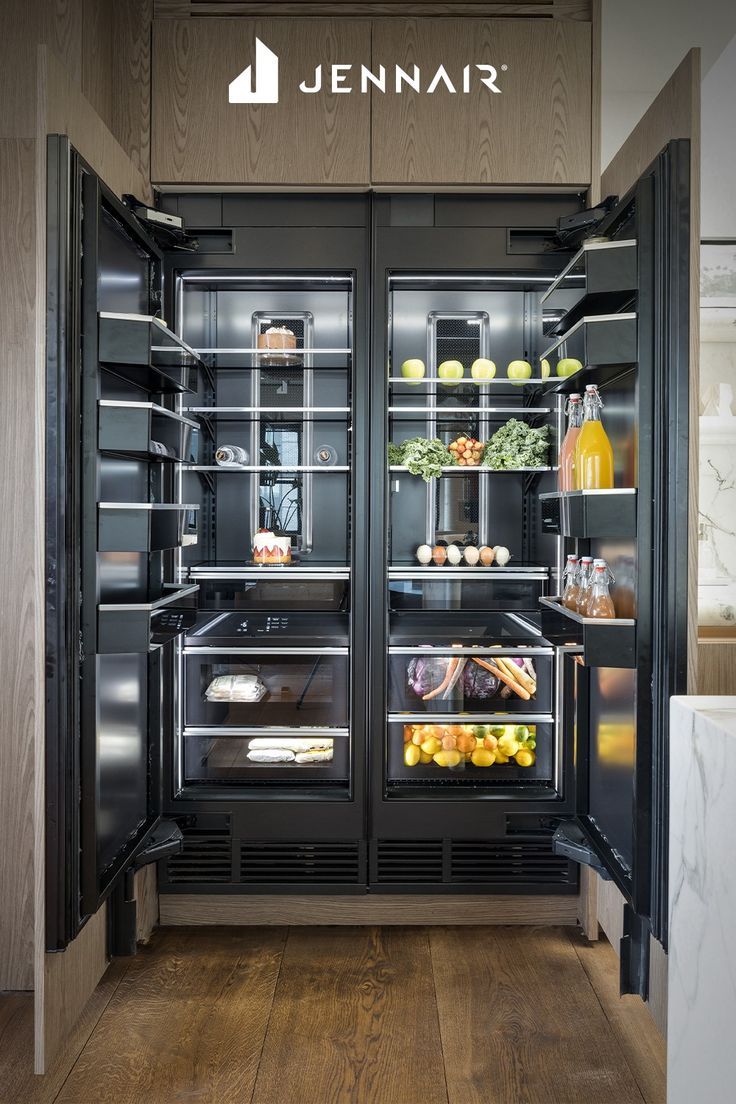 an open refrigerator with its doors wide open and full of food in the fridge is shown